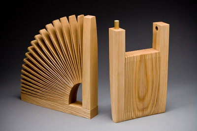 one piece of wood cut and expanded into a bookend