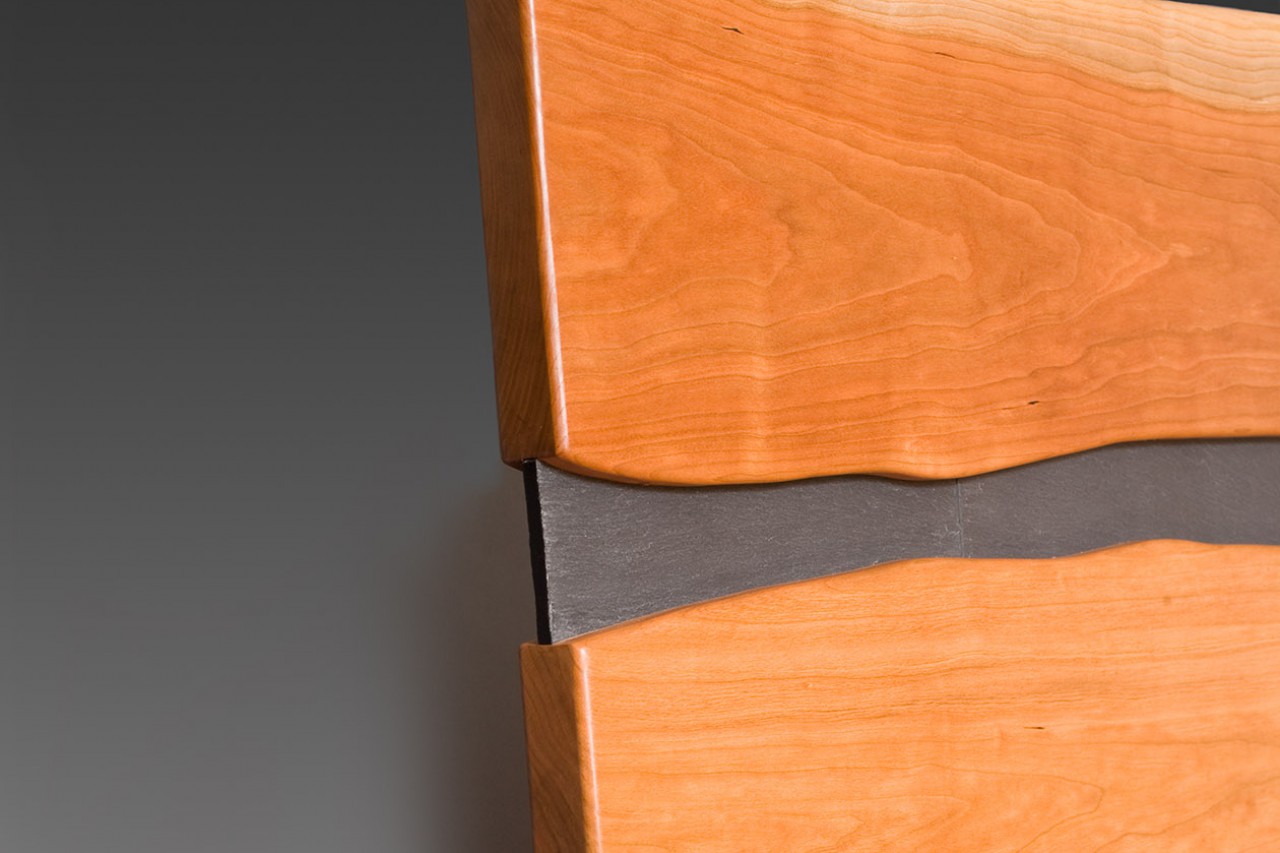Detail of Cayuga cherry bed and nightstand with stone, custom made by Seth Rolland furniture design