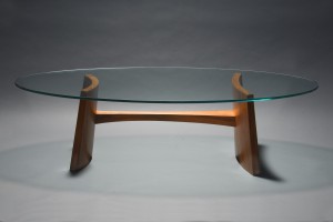 Clearwater coffee table with oval glass and solid coopered walnut wood by Seth Rolland custom furniture design