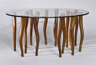 Organic, contemporary coffee table made from solid walnut wood and elliptical glass with stainless steel.