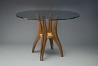 Round cafe table with wood base and glass top hand carved by Seth Rolland custom furniture design