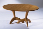 Expanding cherry wood dining table hand carved by Seth Rolland custom furniture design