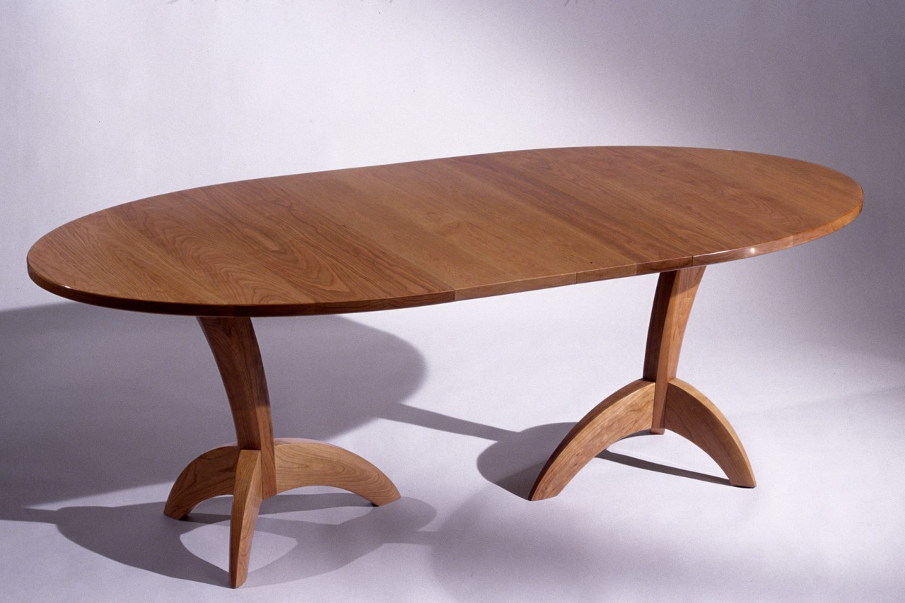Ibis expanding dining table with leaves, solid carved cherry wood, by Seth Rolland custom furniture design