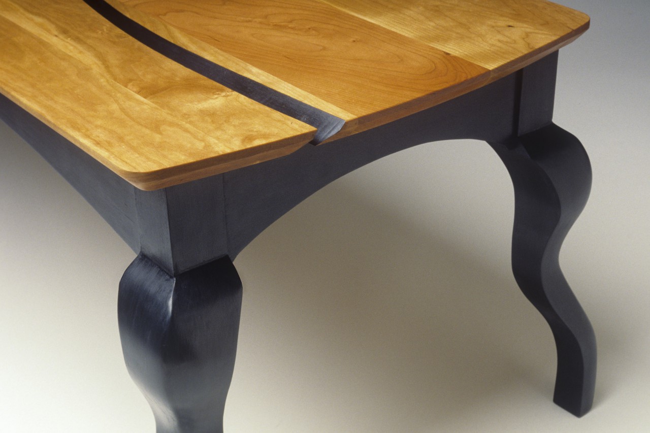 Detail of cherry and milk paint coffee table with carved cabriole legs by Seth Rolland custom furniture design