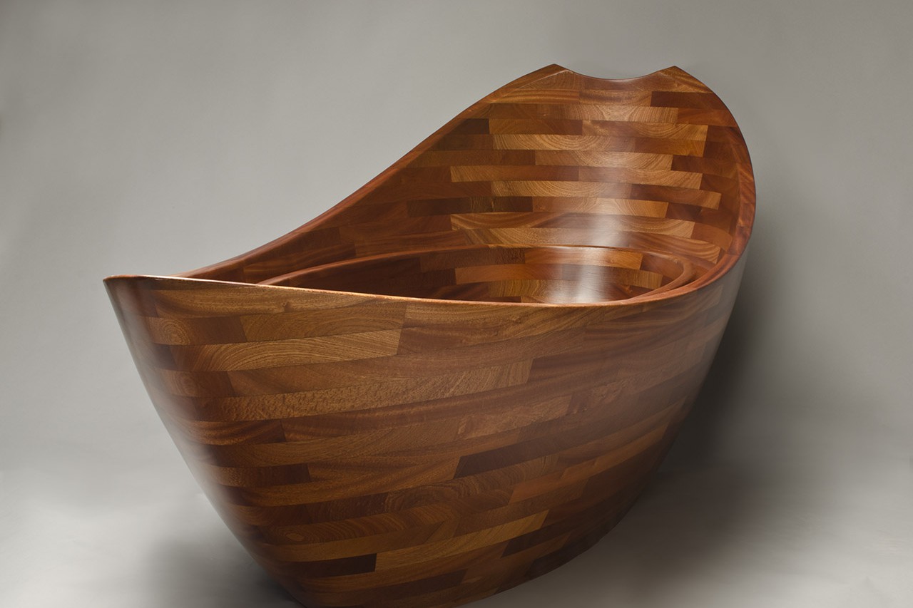 Front view of sculpted wooden bathtub by Seth Rolland custom furniture design
