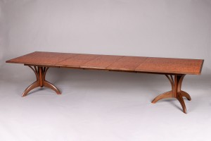 expanding dining table with leaves and custom carved base by Seth Rolland fine furniture design