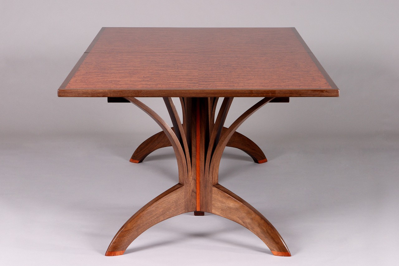 wood dining table crafted from solid walnut and bubinga veneer by Seth Rolland custom furniture design