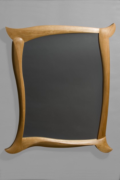 Cherry wood mirror with carved frame by Seth Rolland custom furniture design
