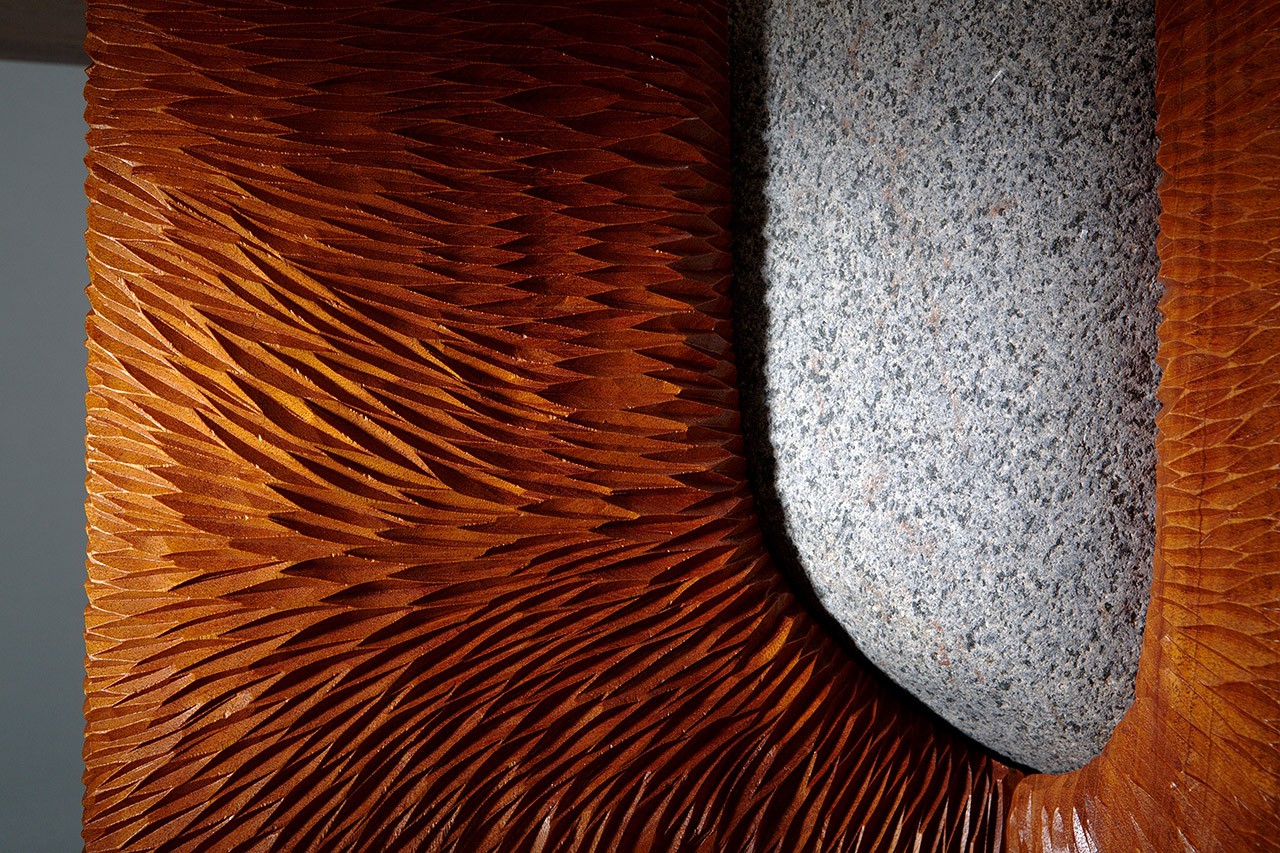 Carved mahogany and stone Tsubo coffee table detail hand carved by Seth Rolland custom furniture design