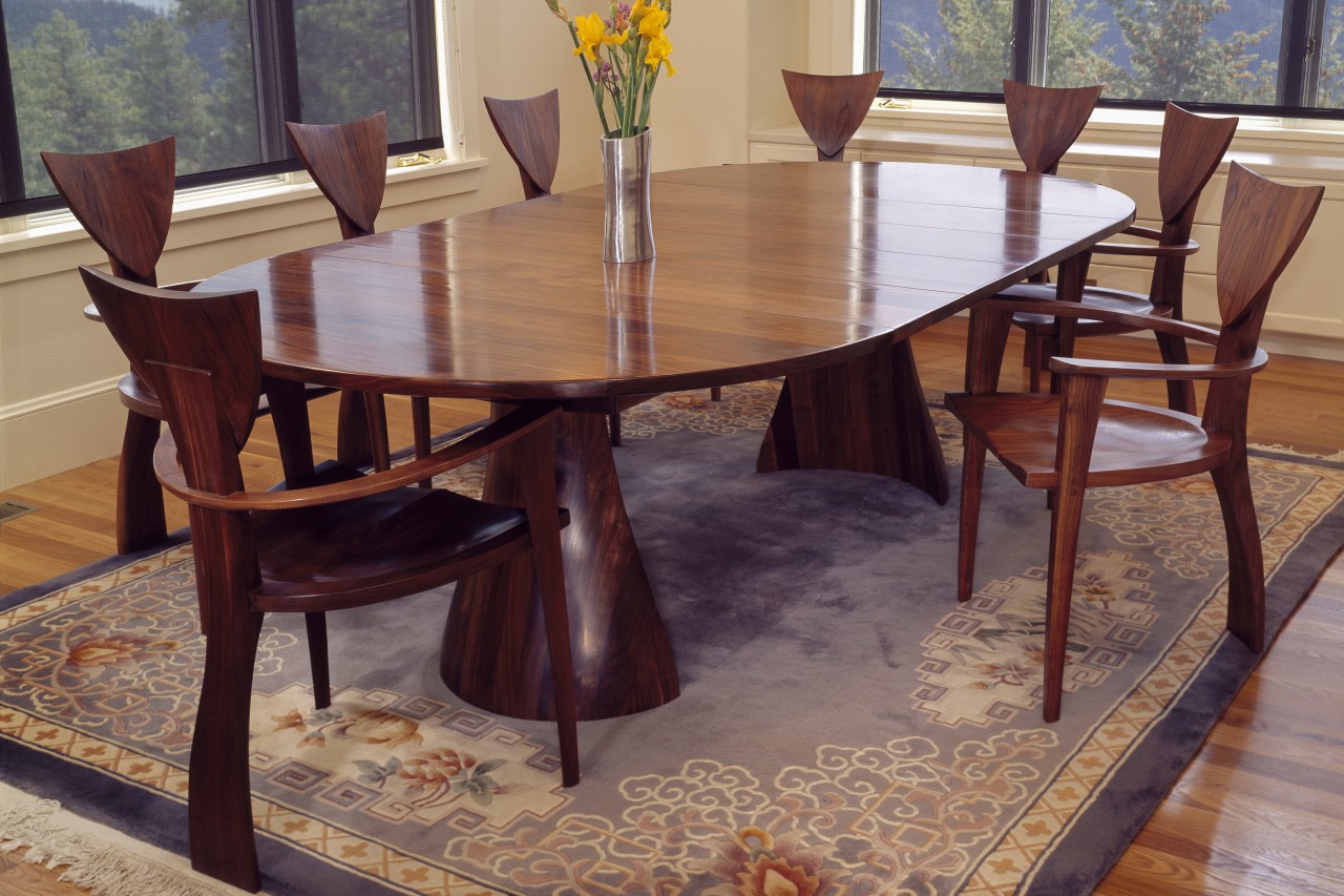 Expanding wood oval Tinsman dining table with organic base and sculptural Finback chairs hand made by Seth Rolland custom furniture design