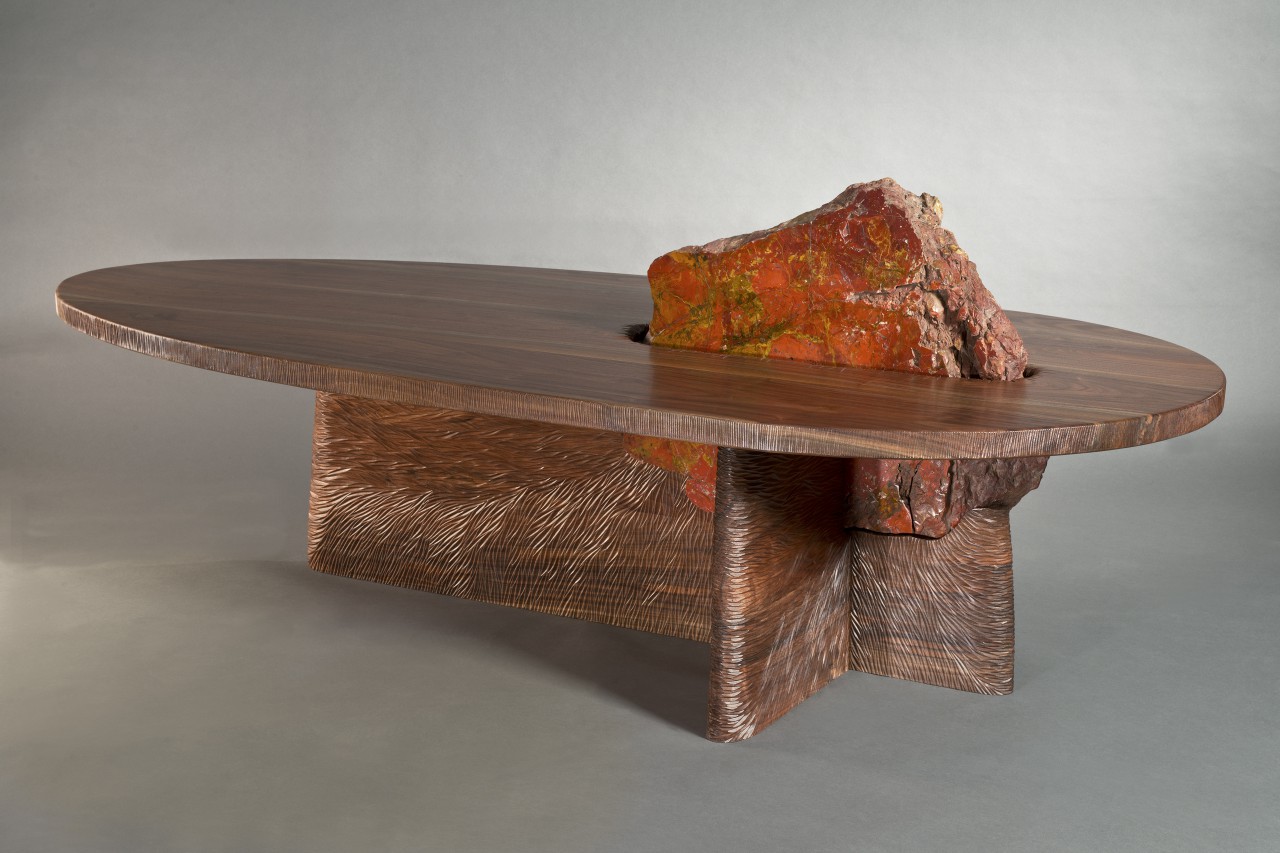 One of a kind wood and stone coffee table with hand carved base.